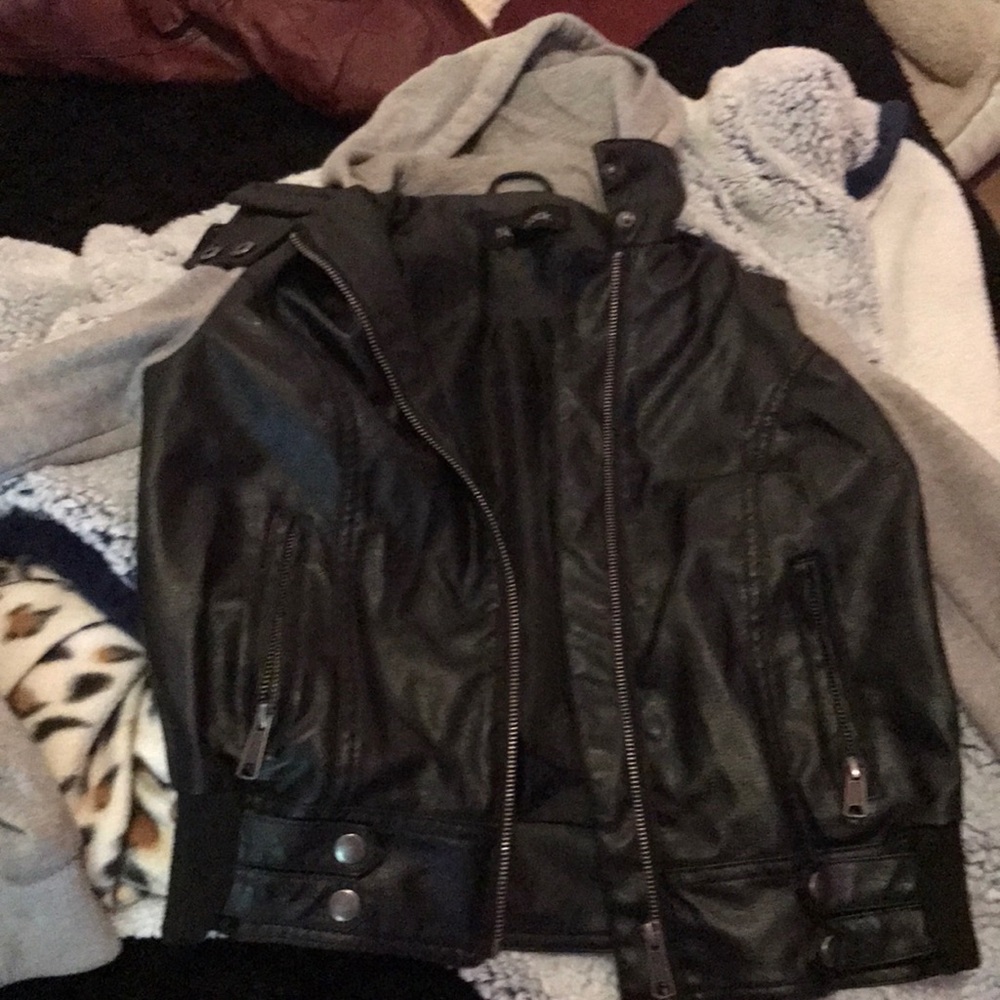 A leather jacket with gray cotton sleeves